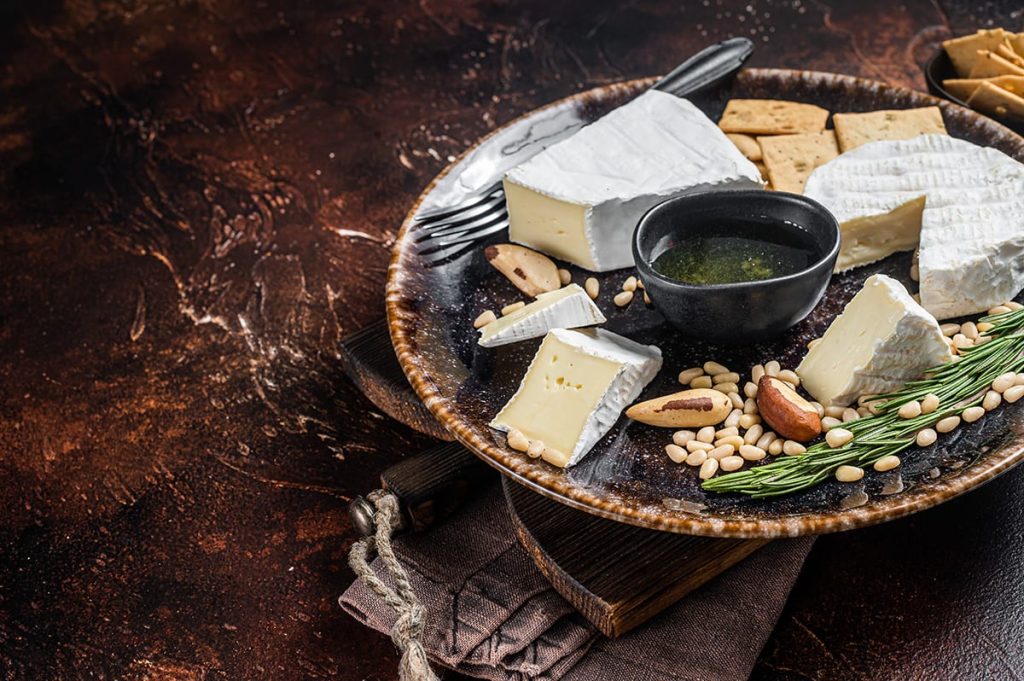 Cheese plate with various cheeses such as brie and camembert